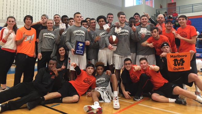 The Marlboro High School boys basketball team and its supporters celebrate a Section 9 Class B title Sunday at SUNY New Paltz.
