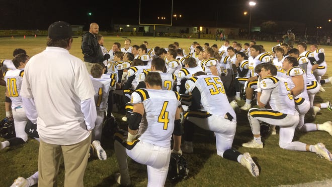 Scotts Hill head football coach Michael Stroup talks to his team moments after the Lions had won their second-round playoff game at Lewis County last week.