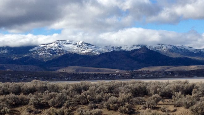 A file photo showing snowcapped mountains in north Reno. National Weather Service forecasters say a winter storm could blast wind, rain and mountain snow along the Sierra starting Friday.