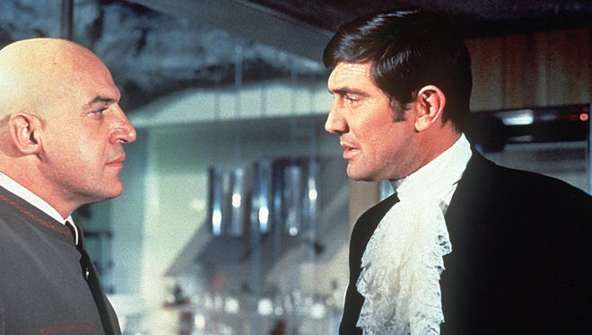 James Bond (George Lazenby, right) faces off against supervillain Blofeld (Telly Savalas) in the 1969 installment "On Her Majesty's Secret Service."