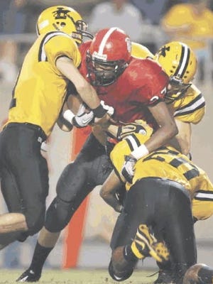 Lincolnton tacklers bring down South Point's Devan Robbins early in their 2010 matchup in Belmont.