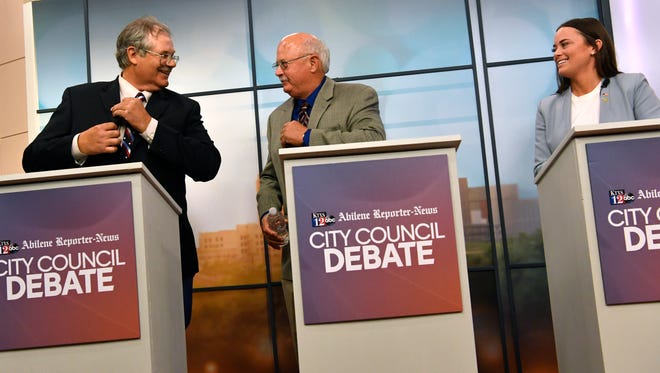 Bruce Kreitler (from left), Jack Rentz, and Alex Russell congratulate each other at the end of Wednesday's debate for Place 2 on the Abilene City Council.