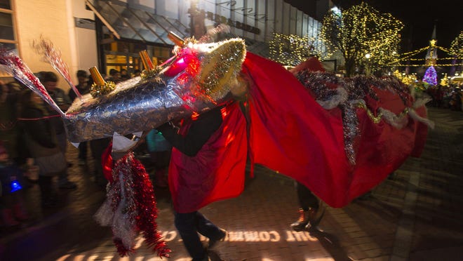 A dragon joins other fiery creatures in a parade down Church Street during First Night Burlington on Thursday, December 31, 2015.