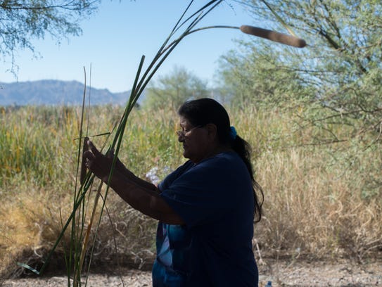 Yolanda Elias cleans reeds in Phoenix on Sept. 16,