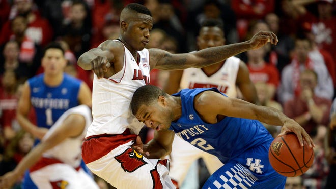 Dec 27, 2014; Louisville, KY, USA; Kentucky Wildcats guard Aaron Harrison (2) dribbles against Louisville Cardinals guard Terry Rozier (0) during the second half at KFC Yum! Center. Kentucky defeated Louisville 58-50.  Mandatory Credit: Jamie Rhodes-USA TODAY Sports
