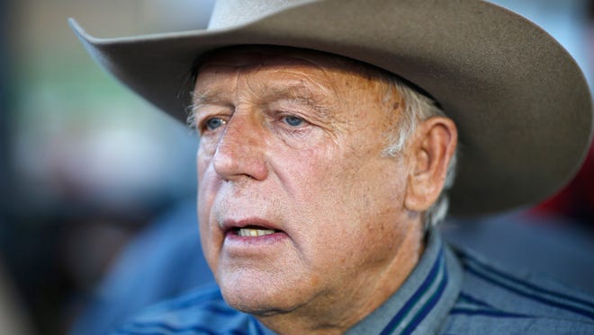 In this April 11, 2015, file photo, Nevada rancher Cliven Bundy speaks with supporters at an event in Bunkerville, Nev. A federal judge in Nevada is considering crucial rulings about what jurors will hear in the trial of six defendants accused of stopping U.S. agents at gunpoint from rounding up cattle near Cliven Bundy's ranch in April 2014.