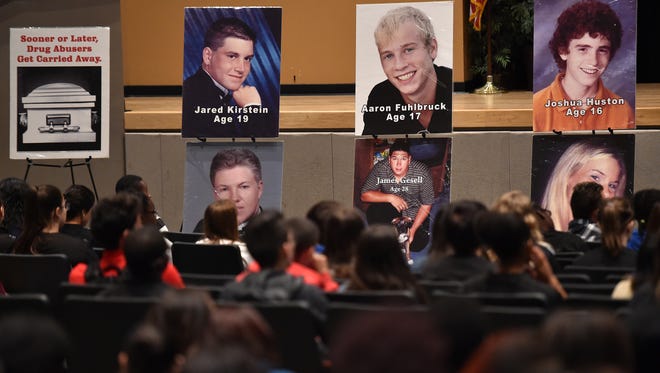 Portraits of victims from fatal drug overdoses are seen by the junior class at Treasure Coast High School during a NOPE, Narcotics Overdose Prevention and Education, event at the school’s auditorium on Nov. 14, 2016, in Port St. Lucie. "We bring information to our students about the use of drugs and their consequences," said Deputy Sergio Lopez, of the St. Lucie County Sheriff’s Office, and moderator for NOPE.