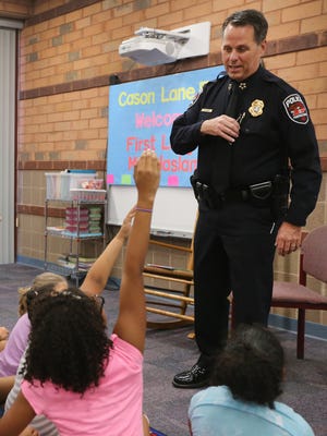 Murfreesboro Police Chief Karl Durr talks with Cason Lane Academy ESP students about the importance of reading, on Monday, Sept. 12, 2016.