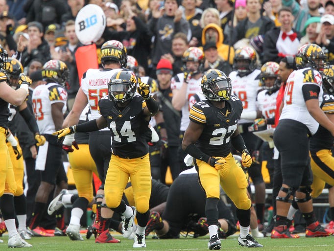Iowa's Desmond King (14) and Jordan Lomax (27) celebrate