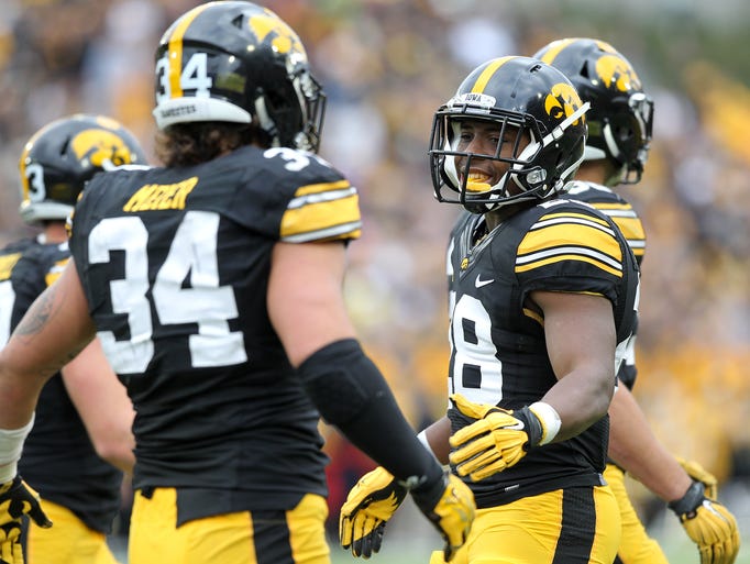 Iowa's Maurice Fleming high-fives Nate Meier as they