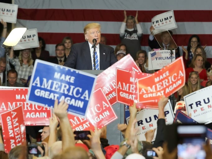 Donald Trump supporters applaud the Republican presidential