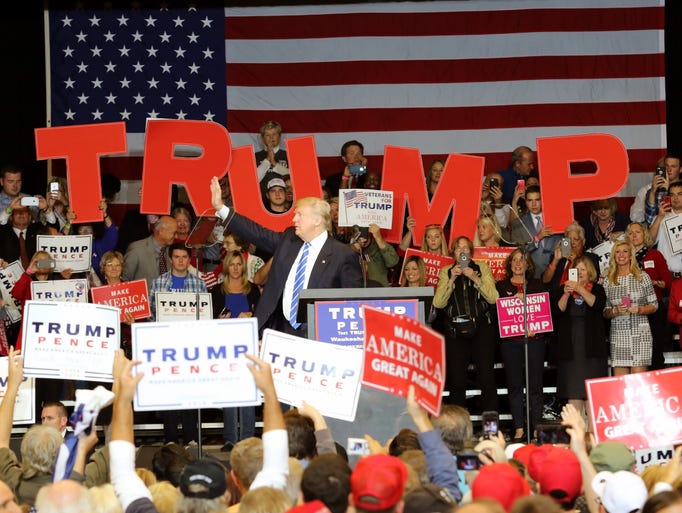 Republican presidential candidate Donald Trump waves