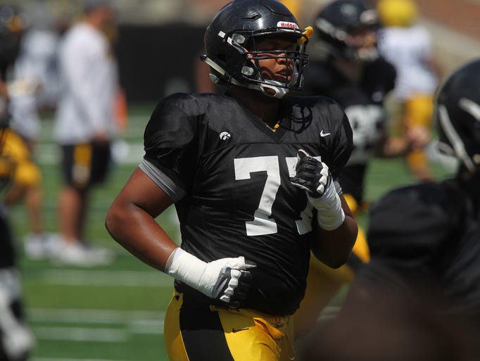 Iowa's Alaric Jackson runs drills during the open practice