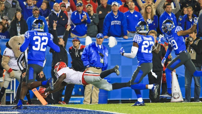 Georgia's Sony Michel hits the end zone pylon as he scores a third quarter touchdown to help put the Bulldogs over the Wildcats Saturday evening, Nov. 5 at Commonwealth Stadium. The Wildcats lost 27-24.