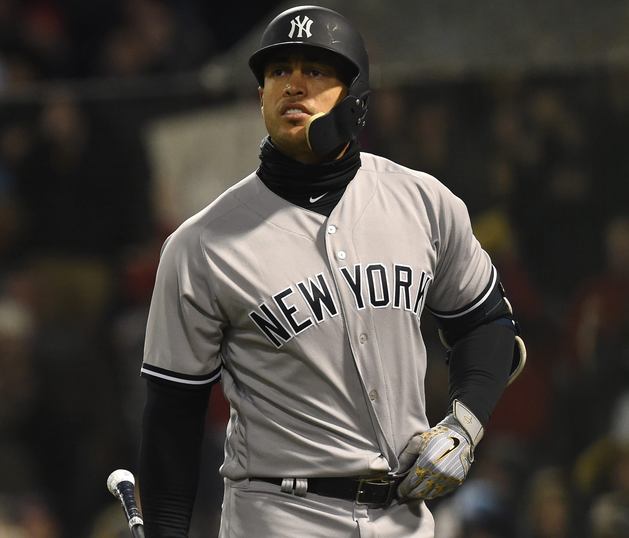 Yankees slugger Giancarlo Stanton walks back to the dugout after striking out for the second time in as many at bats against the Red Sox at Fenway Park in Boston.