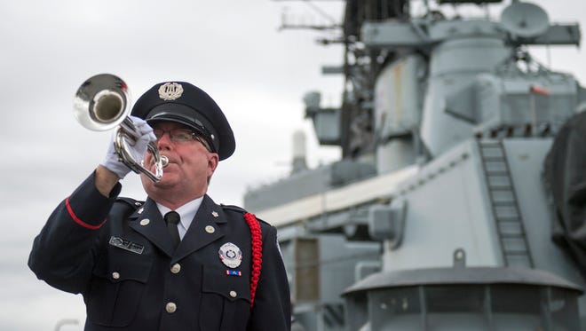 Greg Murphy plays Taps aboard the USS New Jersey Tuesday, Dec. 5, 2017 in Camden, New Jersey. A ceremony was held for the 76th anniversary of the attack at Pearl Harbor.