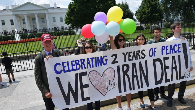 Activist take part in a rally to commemorate the nuclear deal with Iran in front of the White House, on July 14, 2017 in Washington.