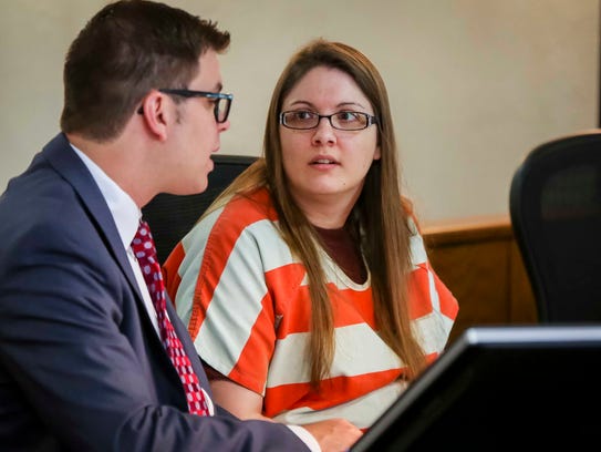 Nicole Finn talks to her lawyers in a Polk County Courthouse