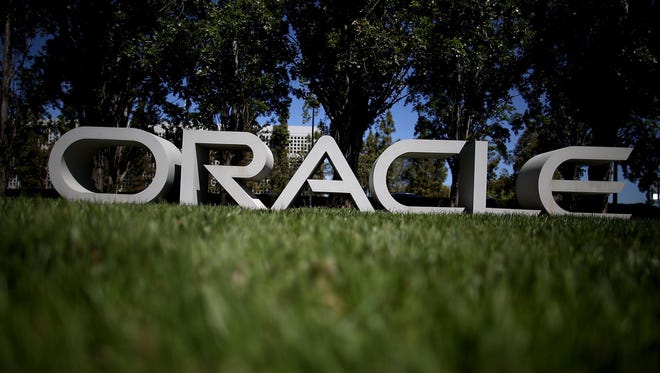 The Oracle logo is displayed in front of the Oracle headquarters on June 19, 2014, in Redwood Shores, Calif.