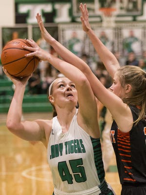 Courtney Raymer of Triton Central High School, is blocked by Beech Grove High School's Mallory Storms, during game action in Fairland, Thursday, January 26, 2017. Triton Central High School won the contest over rival BGHS.