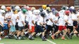High school players go through drills during the Michigan