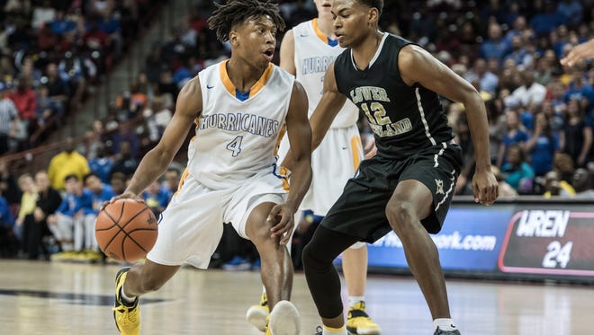 Wren's Jeremiah Neubia (4) drives to the basket as Lower Richland's Clyde Trapp Jr. (12) defends during their Class AAAA boys state championship game Saturday night at Colonial Life Arena. LR won 51-42.