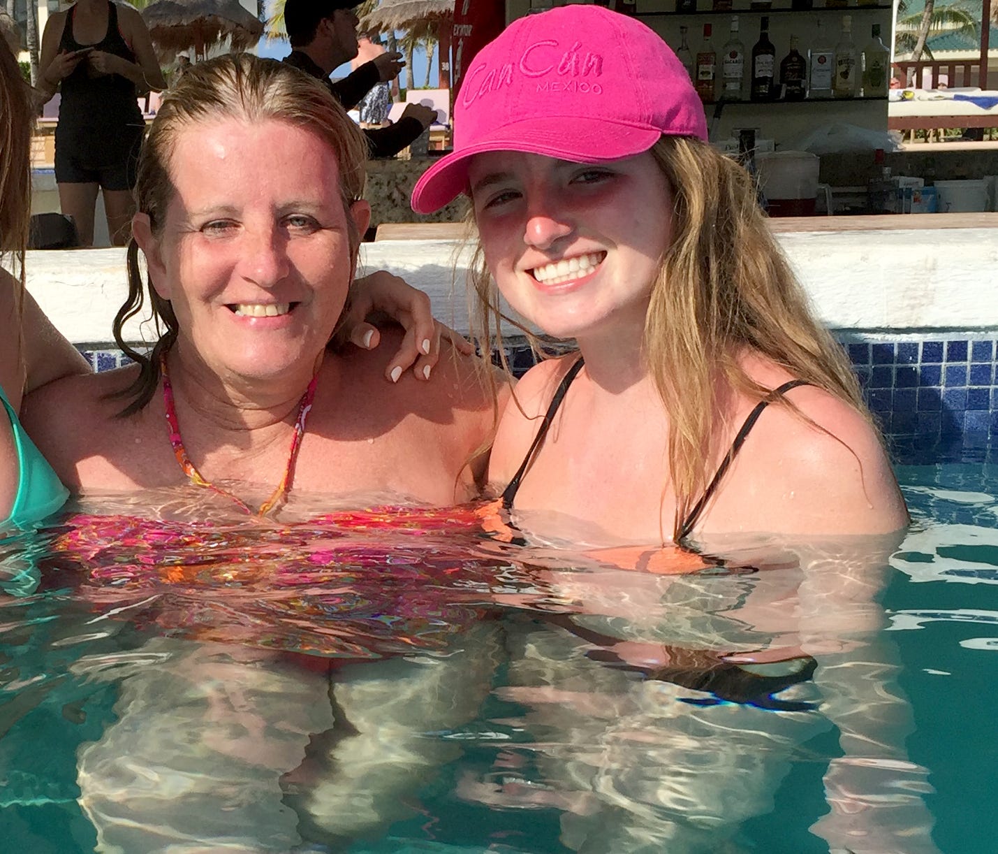 Kathy Daley (left) and her daughter Olivia Daley, 15, sit at the swim-up bar at the Cancun resort moments before Kathy Daley fell ill after having a drink at the bar.  Kathy Daley, her husband and their two teenage children traveled to Iberostar Canc