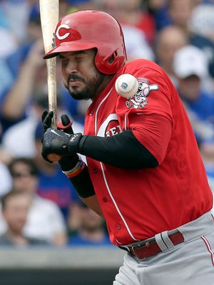 Reds third baseman Eugenio Suarez (7) gets hit by a pitch in the third inning.