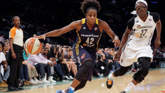 Indiana Fever guard Shenise Johnson (42) drives to the basket past New York Liberty forward Essence Carson (17) during the first half of Game 1 of the WNBA basketball Eastern Conference finals, Wednesday, Sept. 23, 2015 at Madison Square Garden in New York.  (AP Photo/Mary Altaffer)