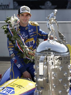 IndyCar driver Alexander Rossi (98) poses for photos following his win in the 100th running of the Indianapolis 500 Monday, May 30, 2016, morning at the Indianapolis Motor Speedway.