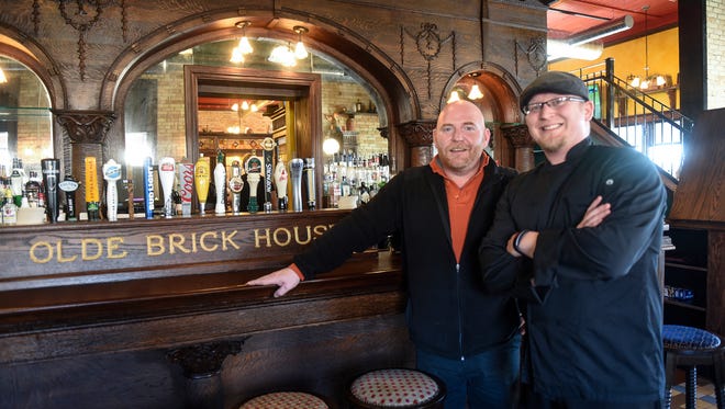 Managing partner Brandon Gunderson and head chef Justin Berhow stand in front of the bar Friday, Feb. 17, at the Olde Brick House in St. Cloud.
