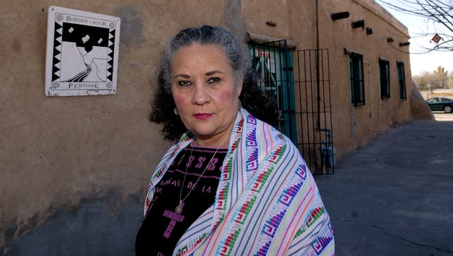 Denise Chavez poses outside the Cultural Center de Mesilla, an adobe brick building that she said was built in the 1840s, in Mesilla, N.M, on Wednesday, Nov. 30, 2005.