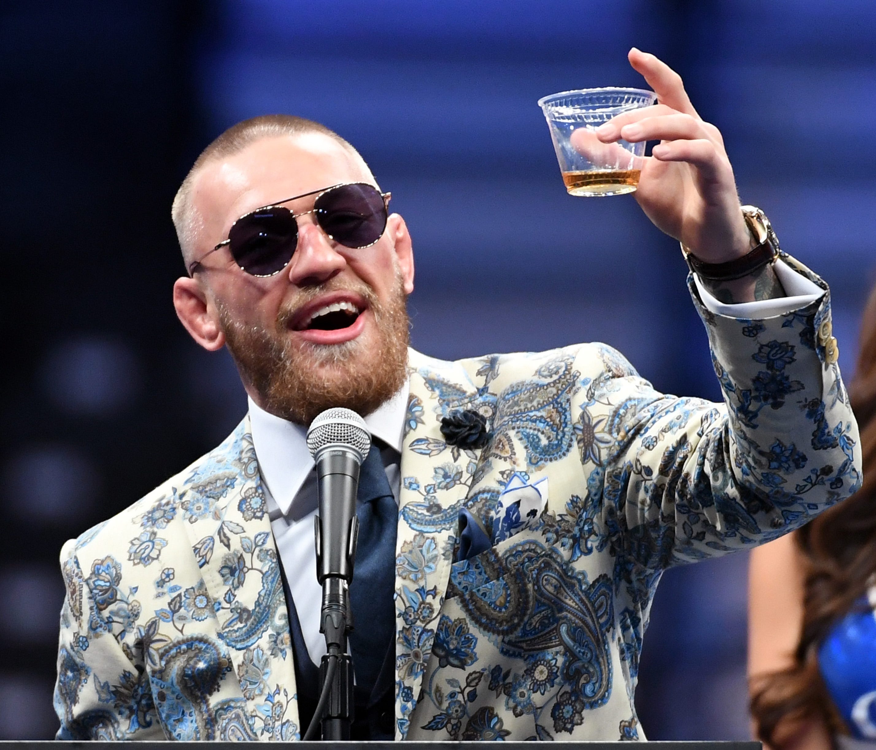 LAS VEGAS, NV - AUGUST 26:  Conor McGregor holds up a drink as he speaks during a news conference after his 10th-round TKO loss to Floyd Mayweather Jr. in their super welterweight boxing match at T-Mobile Arena on August 26, 2017 in Las Vegas, Nevada