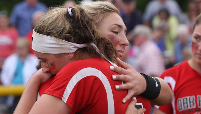 Ashley Riley, right, and Maddy Rathbun hug following the last game of Rathbun's high school career.