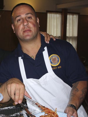 Neil Raciti serves spaghetti in  North Brunswick in 2010. He has been suspended from his job as a Sheriff's officer.