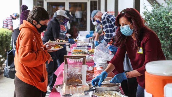 Sunrise Community Church volunteers serve Thanksgiving meals to those experiencing homelessness in Austin on Thursday. Homelessness is likely to be one of the most long-lasting and detrimental effects of the pandemic, Vicki Spriggs writes.