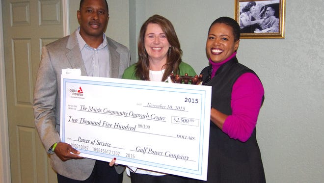 Candy Nowling (center), executive director of The Matrix Community Outreach Center, receives a $2,500 grant from Gulf Power executives Bernard Johnson Jr., (left) District general manager, and Bentina Terry, vice president of Customer Service and Marketing. The nonprofit was recognized for its dedication to improving the lives of others and helping to build stronger communities.