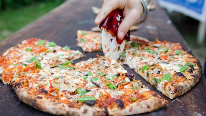 A fresh Veggie Freestyle pizza gets sliced. Zak Neumann/Special to the Press Citizen