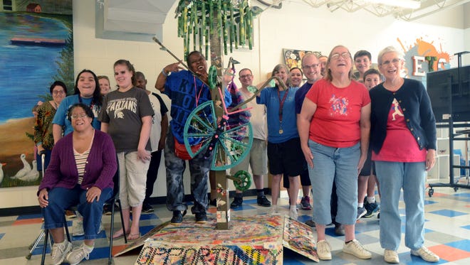 The group that helped build "Accessible Dreams" poses with their art piece. It will be on display at ArtPrize in Grand Rapids Sept. 20-Oct. 8.