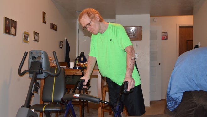 Jim Staton uses a walker to get around his apartment.