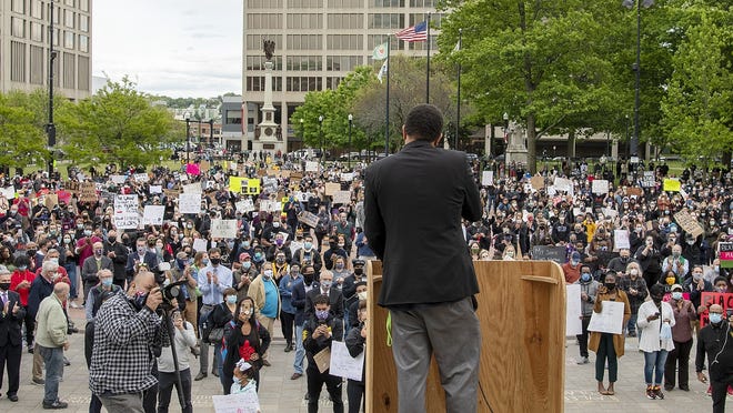 City Councilor-At-Large Khrystian E. King welcomes the crowd to the Worcester Common and begins the speaking program  for a solidarity vigil Monday.