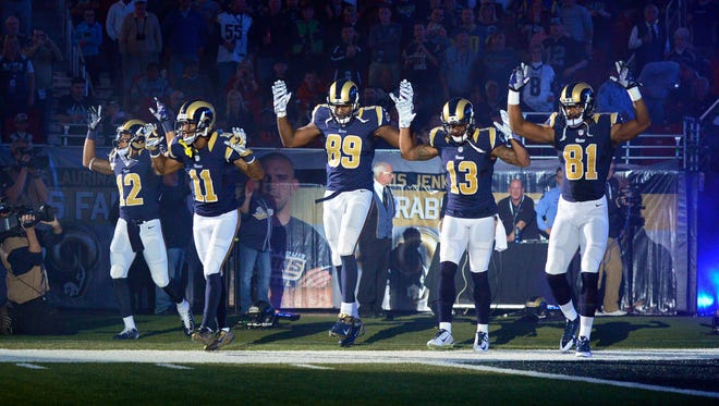 St. Louis Rams put their hands up to show support for Michael Brown before a game against the Oakland Raiders at the Edward Jones Dome.
