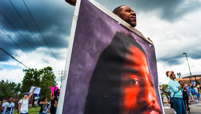 John Thompson protests the verdict in the Philando Castile case this month.