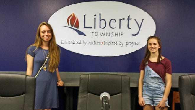 Lilyana Bryan, left, and McKenna Lewis, painted Liberty Township's logo on the wall at the Liberty Township Meeting Center.