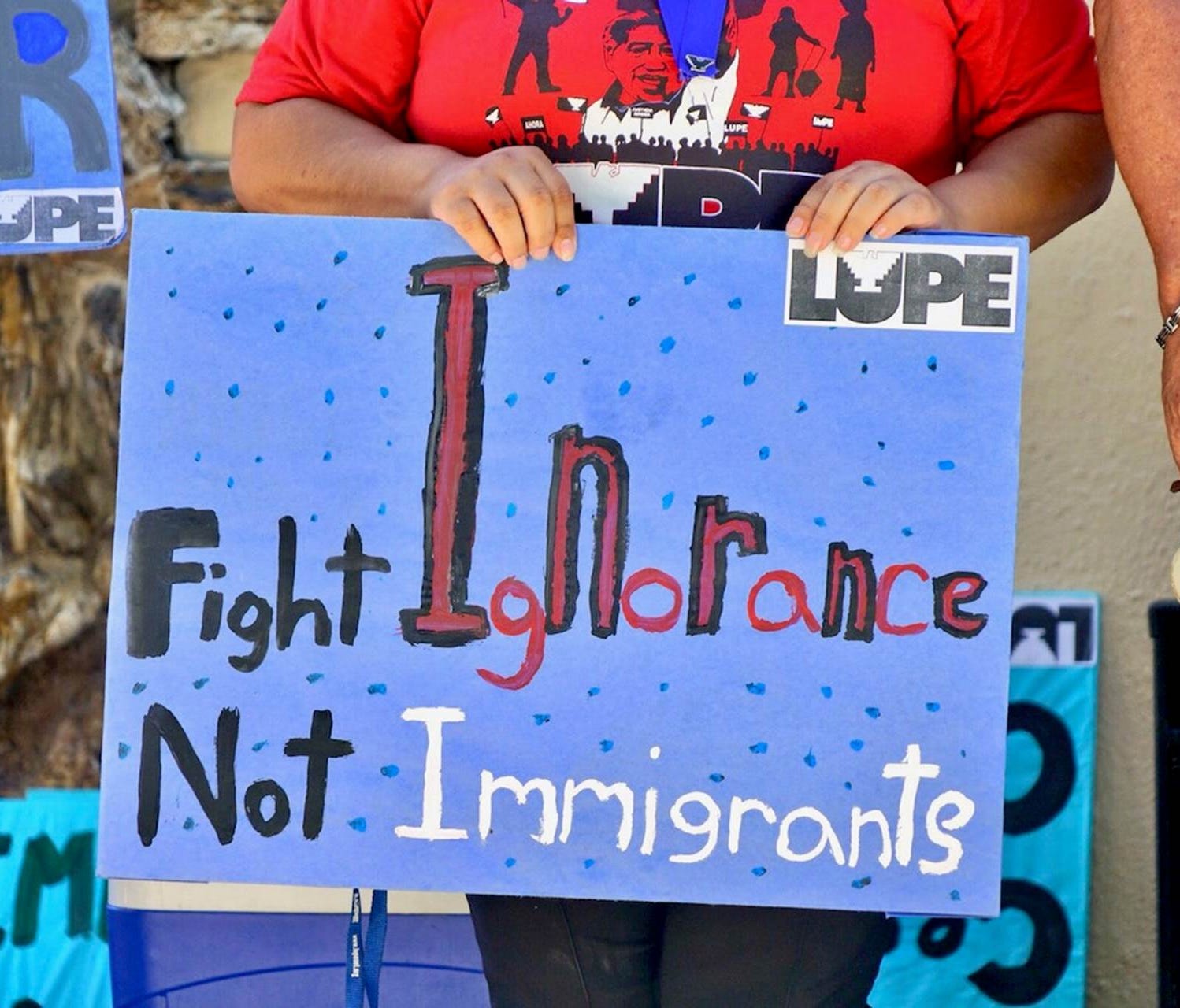 A participant in a Sunday, June 24, 2018, press conference in McAllen, Texas, holds a sign showing support for immigrants who have been targeted by the Trump Administration.