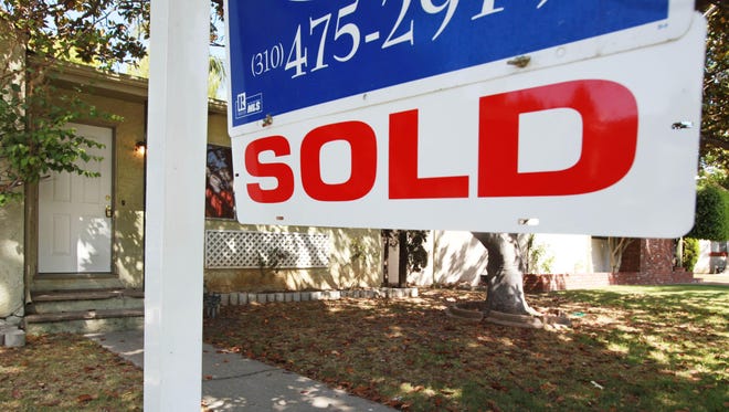 In this June 23, 2009, photo, a “sold” sign is seen on a home for sale.
