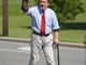 Hamilton County Commissioner Todd Portune waves to the crowd along the parade route in Blue Ash Monday during the 2011 annual Memorial Day parade. Photo by Jim Callaway.