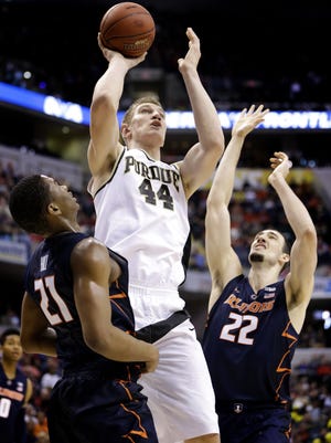 Purdue Boilermakers center Isaac Haas (44) goes up and over Illinois Fighting Illini guard Malcolm Hill (21) for the bucket at Bankers Life Fieldhouse in Indianapolis on March 11, 2016.