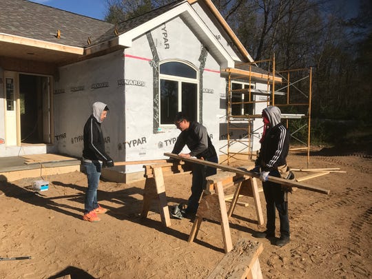 CACC students work on the house Tuesday morning.