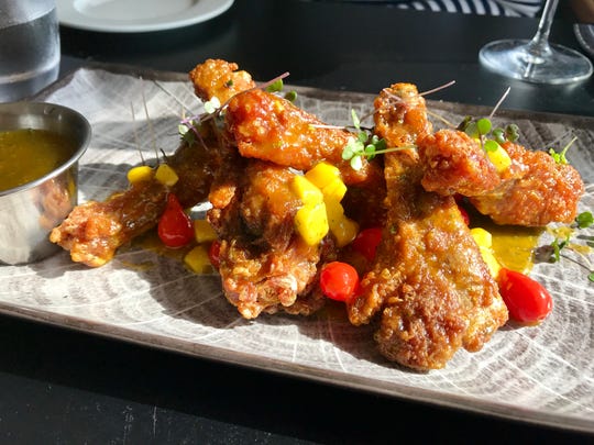 Duck wings in a citrus-chipotle glaze with mango and teardrop peppers from Gather.